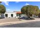 Charming single-story home with a white exterior, red tile roof, mature landscaping, and inviting curb appeal at 7520 E Valley View Rd, Scottsdale, AZ 85250