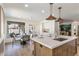 Bright kitchen with island, quartz counters, pendant lights, white cabinets, and an adjacent breakfast nook at 7520 E Valley View Rd, Scottsdale, AZ 85250