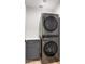 Efficient laundry room with stacked washer and dryer unit and storage cabinet at 7520 E Valley View Rd, Scottsdale, AZ 85250