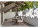 Cozy outdoor patio area featuring two chairs and shade from mature landscaping at 7520 E Valley View Rd, Scottsdale, AZ 85250