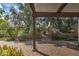 Brick patio with an overhead pergola that looks out to a landscaped yard with a black metal fence at 7807 E Granada Rd, Scottsdale, AZ 85257