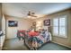 Cozy bedroom with ceiling fan and matching twin beds with shutters at 7807 E Granada Rd, Scottsdale, AZ 85257
