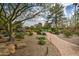 Meandering brick pathway winds through the landscaped community grounds with mature trees at 7807 E Granada Rd, Scottsdale, AZ 85257