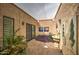 Charming courtyard with lush greenery, textured walls, and a serene fountain, perfect for outdoor enjoyment at 7807 E Granada Rd, Scottsdale, AZ 85257