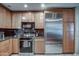 Well-equipped kitchen with stainless steel appliances, wooden cabinets, and granite counters at 7807 E Granada Rd, Scottsdale, AZ 85257