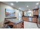 Bright eat-in kitchen boasts stainless steel appliances, wooden cabinetry, bar seating and tile floors at 7807 E Granada Rd, Scottsdale, AZ 85257
