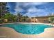 Sparkling community pool with jacuzzi, lounge seating, shade and well-maintained landscaping at 7807 E Granada Rd, Scottsdale, AZ 85257