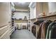 Spacious walk-in closet with extensive shelving and hanging space for organized storage at 7807 E Granada Rd, Scottsdale, AZ 85257