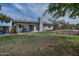 Spacious backyard featuring a well-maintained lawn, covered patio, and neutral-colored exterior at 815 E Paradise Ln, Phoenix, AZ 85022