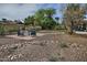 Backyard featuring desert rock landscaping, comfortable seating, and mature trees at 815 E Paradise Ln, Phoenix, AZ 85022
