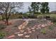 Rock landscaping with stepping stones leads to a seating area in this private backyard at 815 E Paradise Ln, Phoenix, AZ 85022