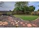 Landscaped backyard featuring a lawn, hot tub, and rock pathways at 815 E Paradise Ln, Phoenix, AZ 85022