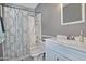 Cozy bathroom with shower and tub combo, white vanity, and hexagon tile floors at 815 E Paradise Ln, Phoenix, AZ 85022