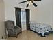 Bedroom with a twin bed, chair, and window with blinds at 815 E Paradise Ln, Phoenix, AZ 85022