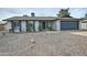 Charming single-story home featuring a low-maintenance gravel yard and a two-car garage at 815 E Paradise Ln, Phoenix, AZ 85022