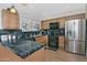 Updated kitchen with stainless steel appliances, dark countertops, and wood cabinets at 815 E Paradise Ln, Phoenix, AZ 85022