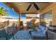 This back patio offers a ceiling fan, outdoor furniture and a stainless steel barbeque at 8402 W Laurel Ln, Peoria, AZ 85345