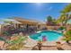 An inviting backyard retreat with a sparkling pool surrounded by lush desert landscaping at 8402 W Laurel Ln, Peoria, AZ 85345