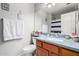 The bathroom has a sink with blue countertops, a large mirror and a shower at 8402 W Laurel Ln, Peoria, AZ 85345