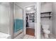 Ensuite bathroom with tile flooring, walk-in closet, a walk-in shower with glass door, and built-in shelving at 8402 W Laurel Ln, Peoria, AZ 85345
