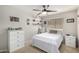 Comfortable bedroom with ample natural light, modern ceiling fan, and a well-organized closet at 8402 W Laurel Ln, Peoria, AZ 85345