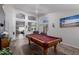 Spacious game room featuring a classic pool table and wood flooring at 8402 W Laurel Ln, Peoria, AZ 85345
