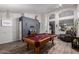 Game room featuring a pool table, wood floors, and open archways at 8402 W Laurel Ln, Peoria, AZ 85345
