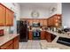 Well-lit kitchen featuring stainless steel appliances, granite countertops, and plenty of cabinet space at 8402 W Laurel Ln, Peoria, AZ 85345