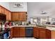 Bright kitchen boasts warm wood cabinets, granite countertops, and a convenient sink overlooking the backyard at 8402 W Laurel Ln, Peoria, AZ 85345