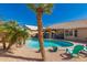 Enjoy poolside relaxation in this backyard oasis surrounded by desert landscaping at 8402 W Laurel Ln, Peoria, AZ 85345