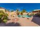 A beautiful backyard with a refreshing pool, palm trees, and comfortable seating on a sunny day at 8402 W Laurel Ln, Peoria, AZ 85345