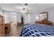 Bedroom featuring light blue walls, a ceiling fan, and an adjoining bathroom at 9333 E University Dr # 113, Mesa, AZ 85207