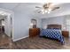 Spacious bedroom with ceiling fan and a wooden dresser with matching bedside tables at 9333 E University Dr # 113, Mesa, AZ 85207