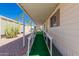 Exterior featuring a covered walkway, ramp, and low-maintenance desert landscaping at 9333 E University Dr # 113, Mesa, AZ 85207