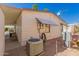 Home exterior with covered patio, AC unit, and desert landscaping, showcasing Southwestern charm at 9333 E University Dr # 113, Mesa, AZ 85207