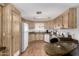 Traditional style kitchen featuring wood cabinets, countertops, and appliances, creating a functional cooking space at 9333 E University Dr # 113, Mesa, AZ 85207