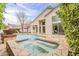 Backyard view with a pool, spa, manicured lawn and waterfall feature, offering a luxurious outdoor experience at 9442 N 118Th St, Scottsdale, AZ 85259