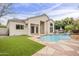 Backyard features a pool with a waterfall feature, lush landscaping, and a spacious patio perfect for entertaining at 9442 N 118Th St, Scottsdale, AZ 85259