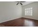 Bright bedroom featuring wood floors, white walls, and a shuttered window at 9442 N 118Th St, Scottsdale, AZ 85259