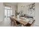 Light and airy dining room featuring a wooden table, modern chairs, and decorative art on the walls at 9442 N 118Th St, Scottsdale, AZ 85259