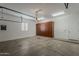 Garage featuring a window, utility cabinet, and fluorescent light fixture at 9442 N 118Th St, Scottsdale, AZ 85259