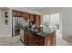 Island kitchen boasts stainless appliances, dark countertops, and outdoor patio access at 9442 N 118Th St, Scottsdale, AZ 85259