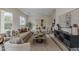 Open living room with comfortable seating, a modern rug, and stylish decor at 9442 N 118Th St, Scottsdale, AZ 85259