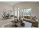 Bright, open living room with tall ceilings, large windows, and modern furnishings at 9442 N 118Th St, Scottsdale, AZ 85259