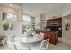 Open-concept space with kitchen island, breakfast nook with marble table, and views to a beautifully landscaped yard at 9442 N 118Th St, Scottsdale, AZ 85259