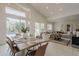 Open-concept living and dining area with view of the pool through large glass doors and lots of natural light at 9442 N 118Th St, Scottsdale, AZ 85259