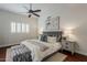 A beautiful primary bedroom featuring a ceiling fan, accent pillows and matching nightstands at 9442 N 118Th St, Scottsdale, AZ 85259