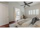 Relaxing primary bedroom featuring a ceiling fan, hardwood floors, and ensuite bathroom at 9442 N 118Th St, Scottsdale, AZ 85259