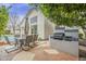 Outdoor kitchen area with built-in grill and dining set next to the pool offers a perfect entertainment space at 9442 N 118Th St, Scottsdale, AZ 85259