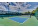 Community pickleball courts with green and blue surfacing and surrounded by fencing at 9442 N 118Th St, Scottsdale, AZ 85259